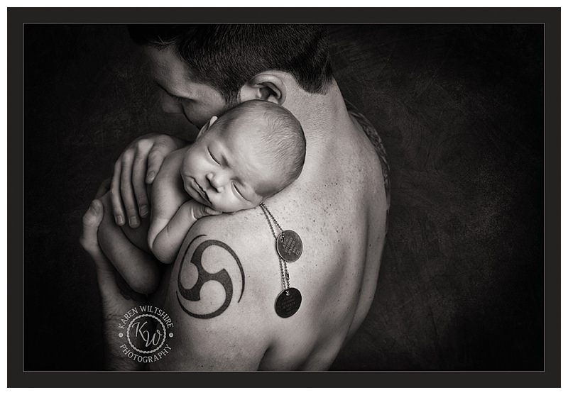 dad holding baby in black and white
