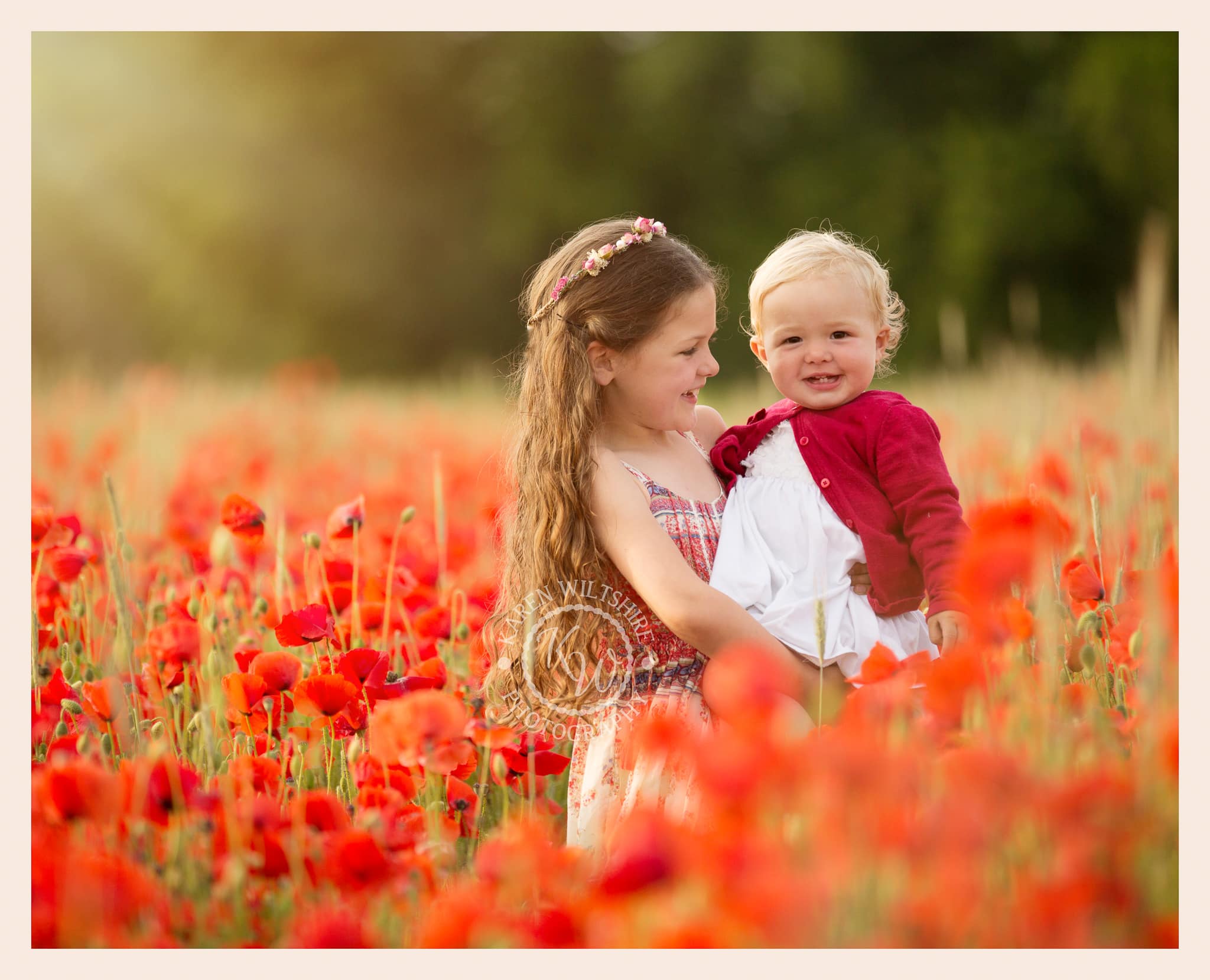 Sisters in field of red poppies