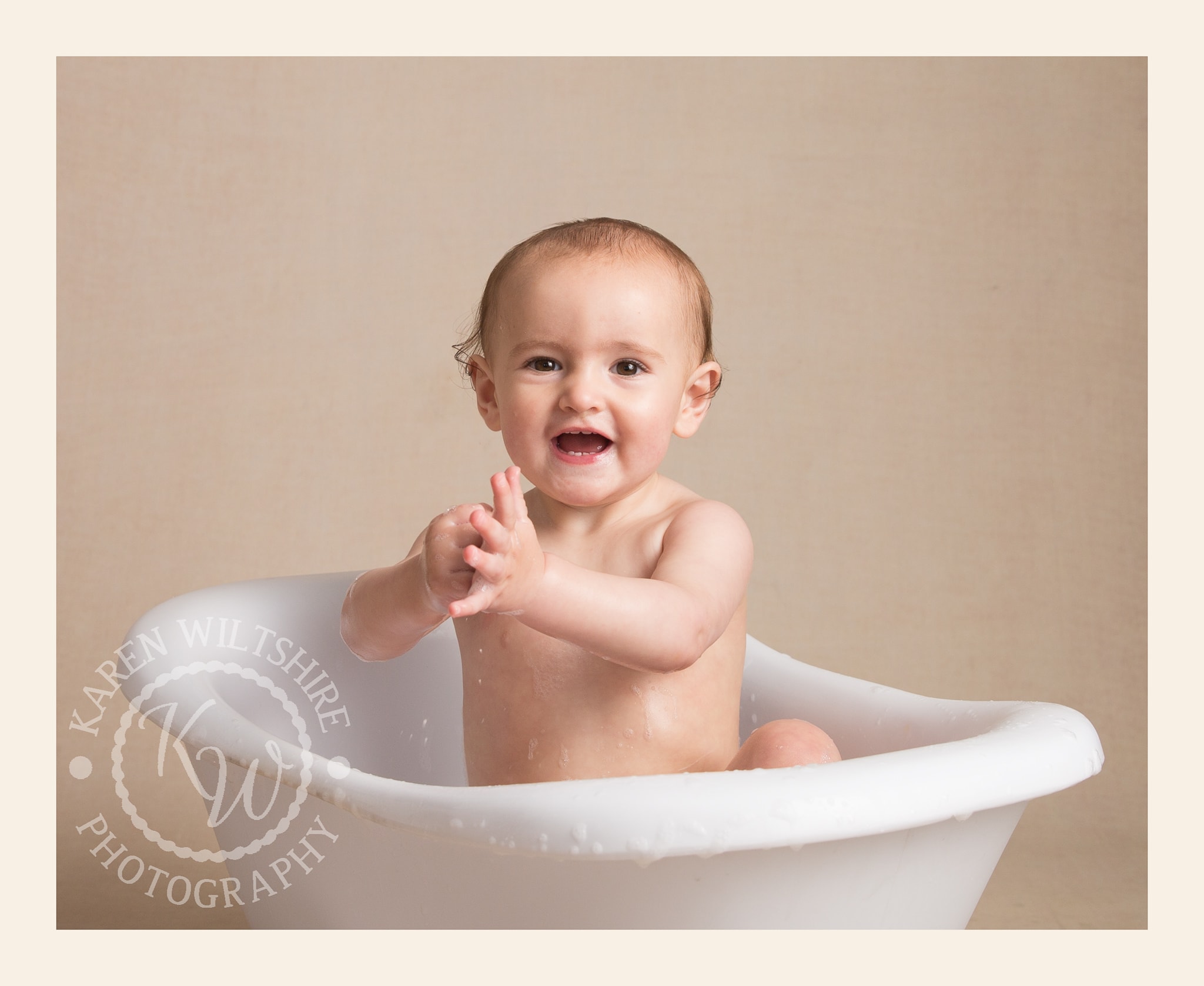 Baby clapping in bath