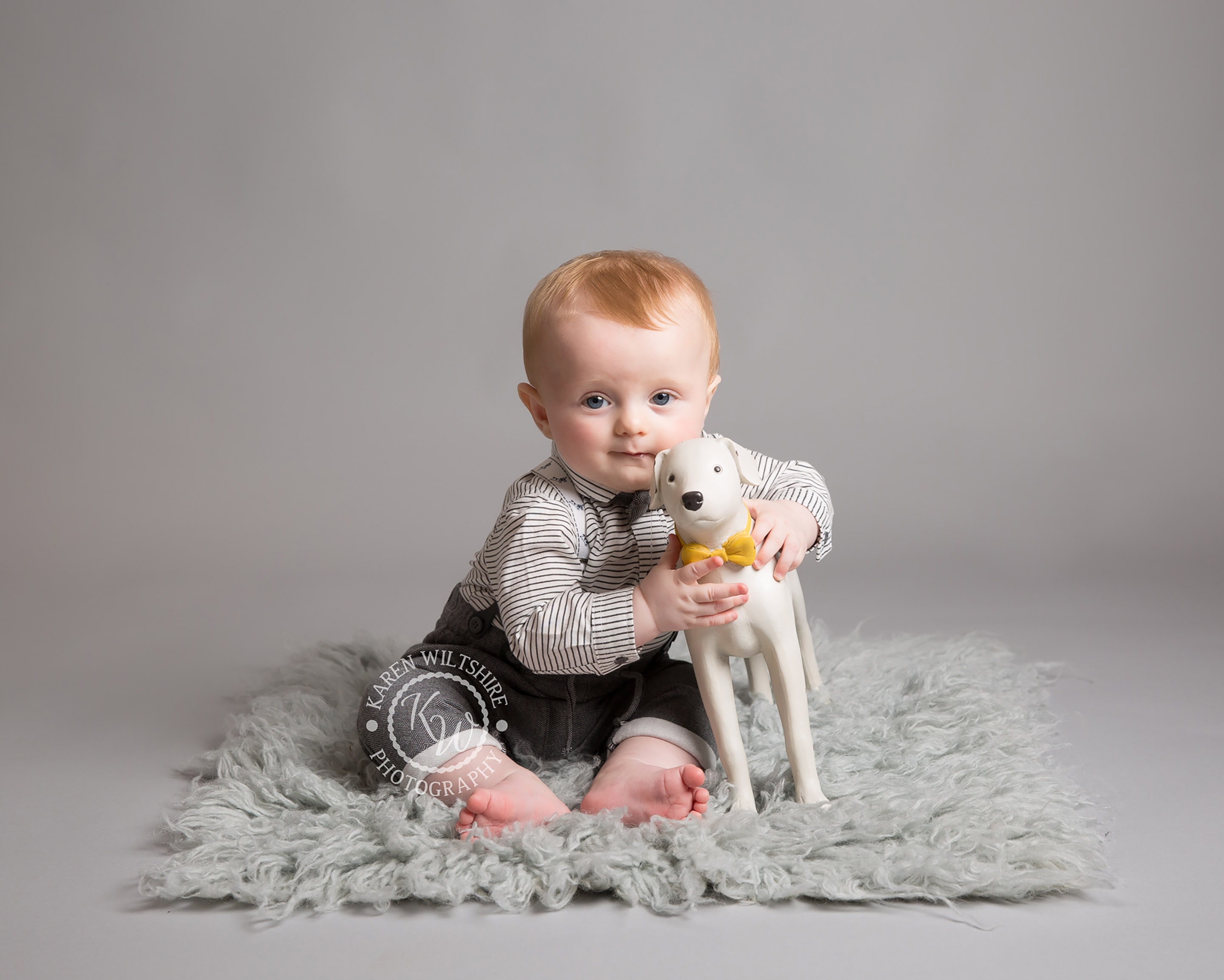 baby with toy dog at his Baby photoshoot with KW Photography
