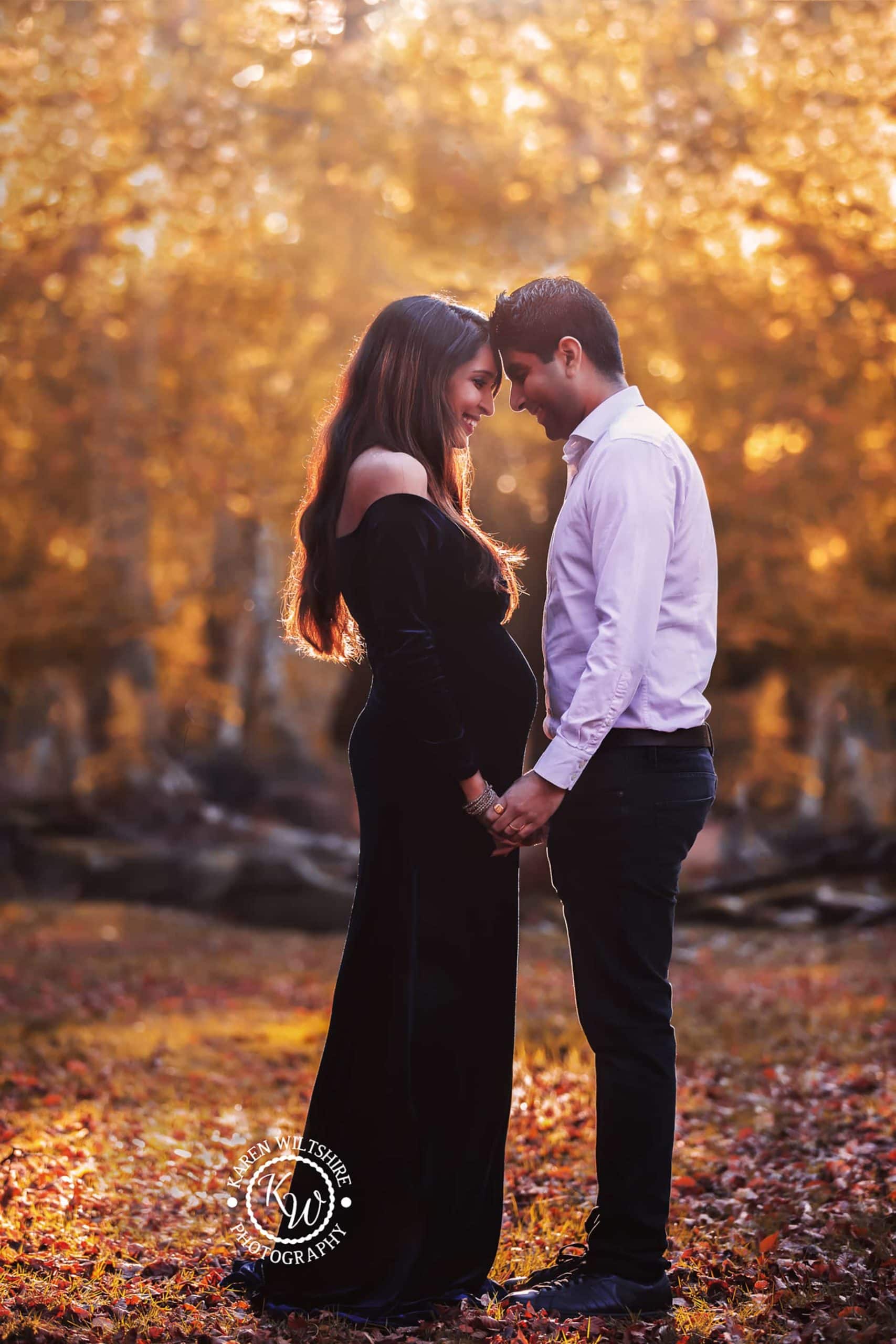 husband and wife posed together for bump photoshoot